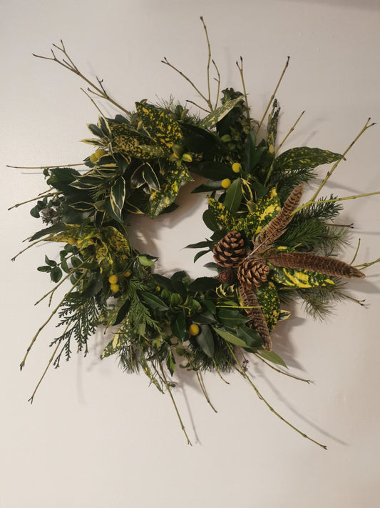 Green foliage with hints of yellow, christmas wreath.