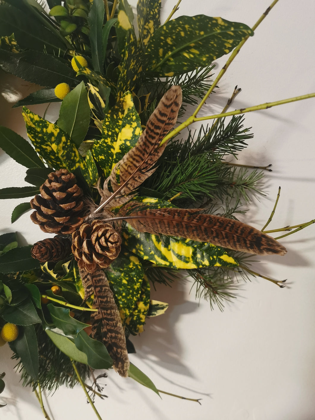 Green foliage with hints of yellow, christmas wreath.