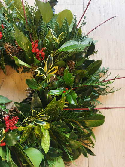 Green foliage with hints of red, christmas wreath.