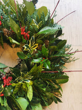 Load image into Gallery viewer, Green foliage with hints of red, christmas wreath.
